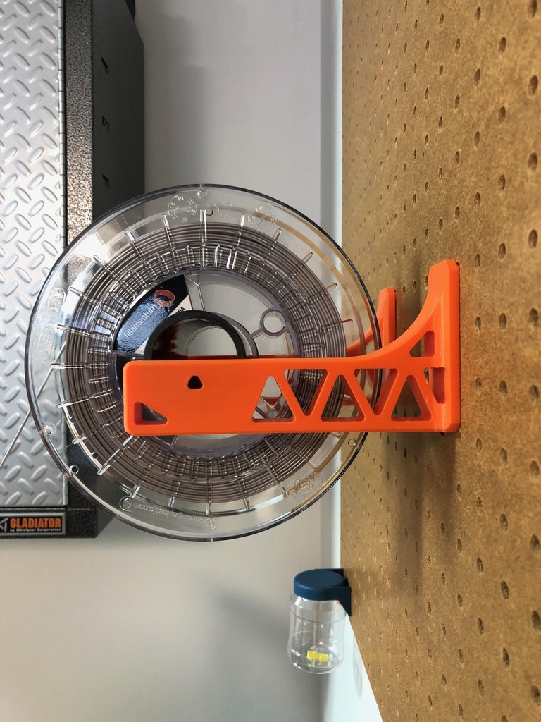 Filament spool holder bracket for pegboard mounting