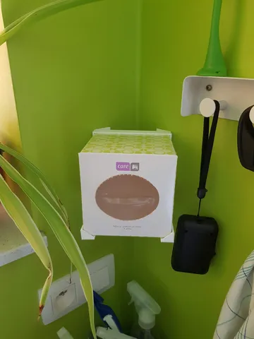Corner mounted tissue box holder