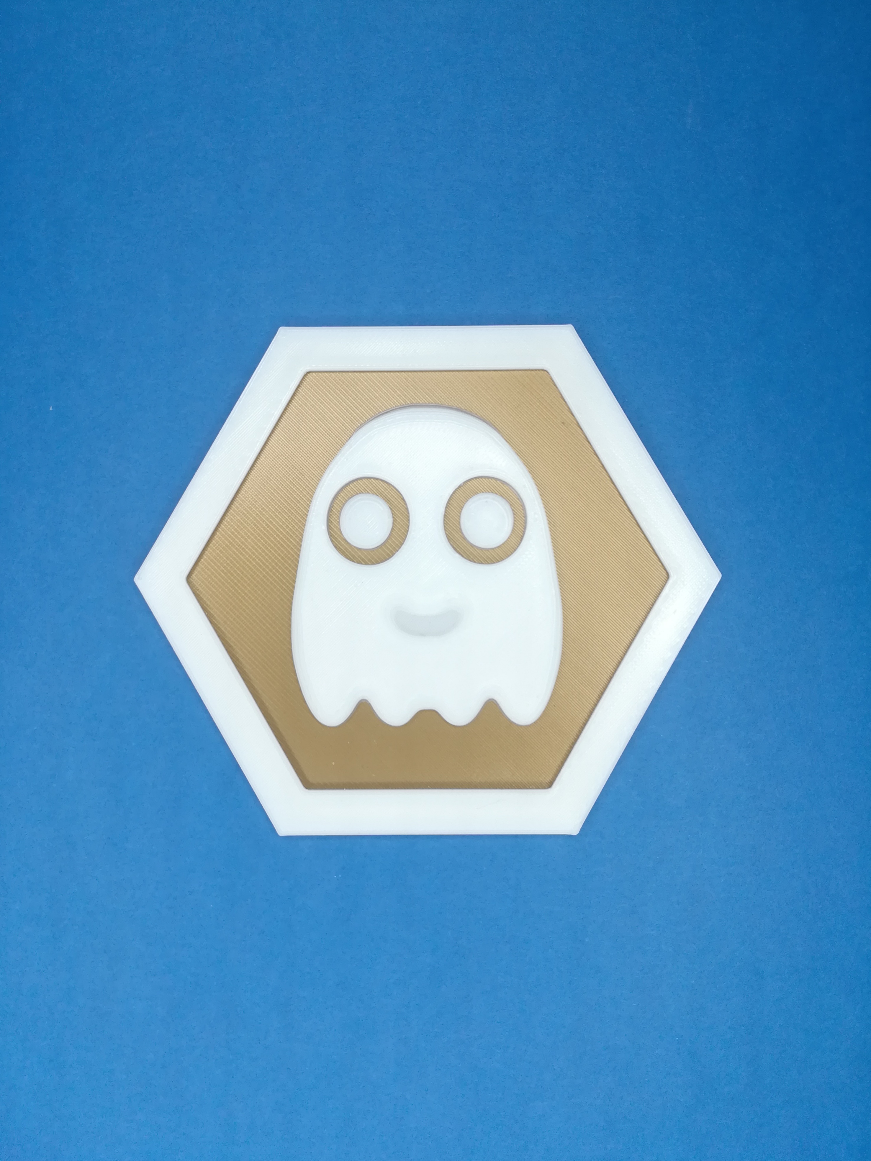 Hexagonal ghost Pacman inspired tile coin logo