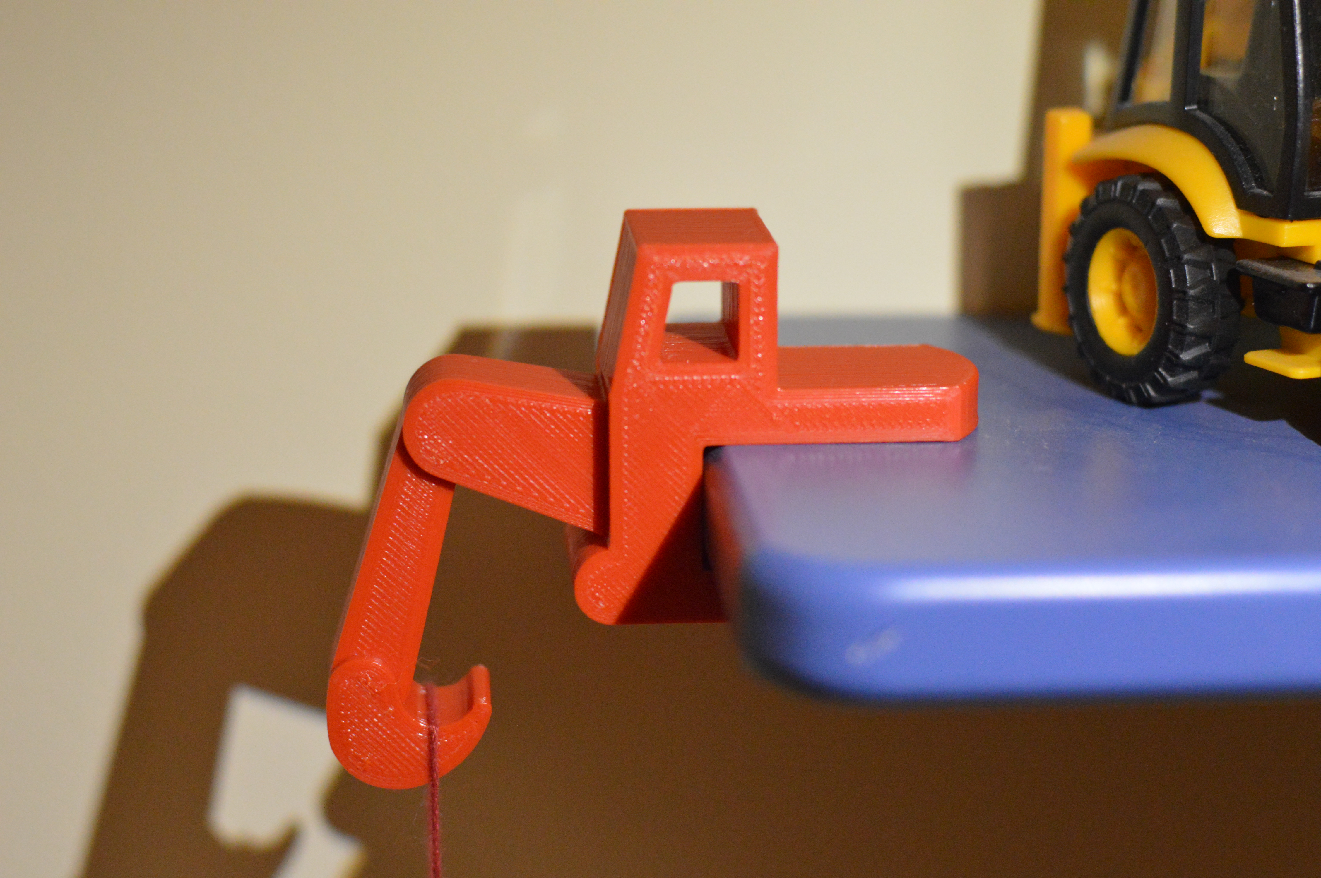 Digger-shaped shelf hook