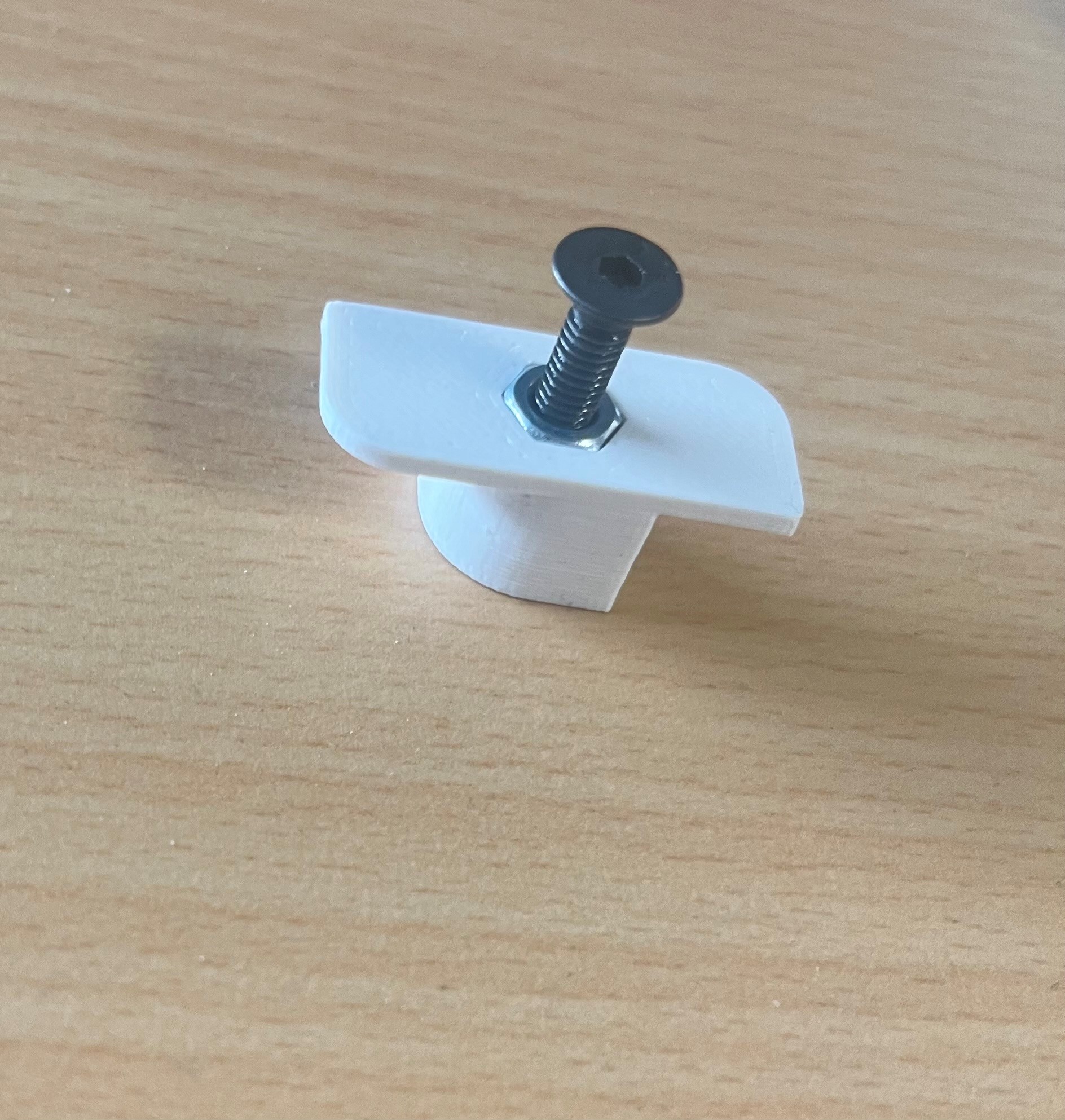 Acoustic panel mounting bracket with hole for nut