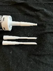 Caulk gun extension and cap