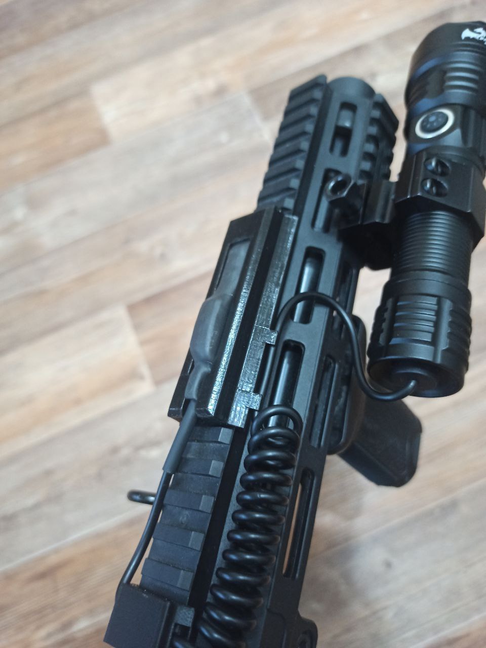 Flashlight button holder