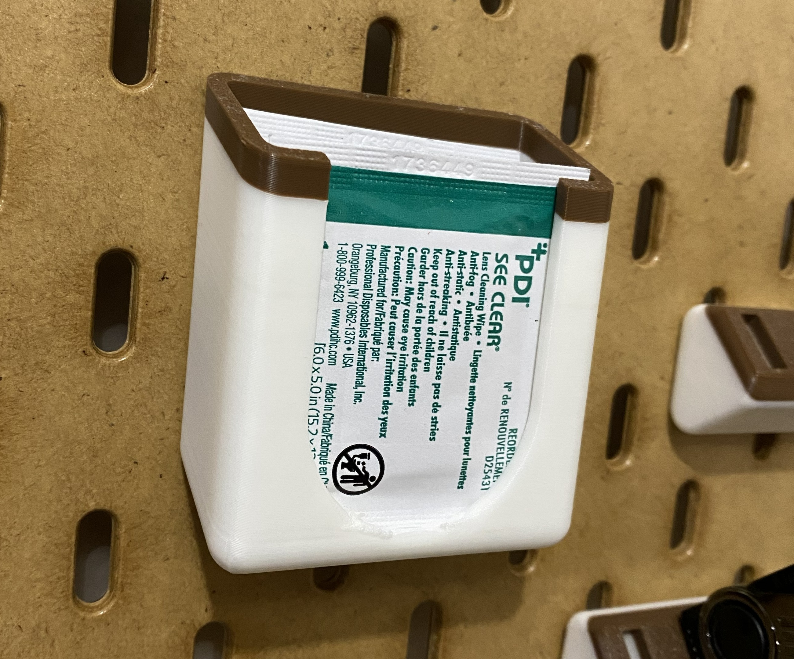 Skadis eyeglass lense cleaner holder