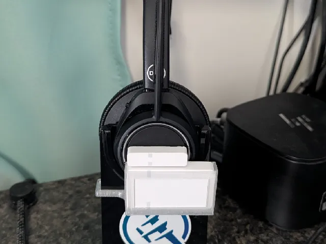 Mount for Z-wave door sensor to a Plantronics headset charger.