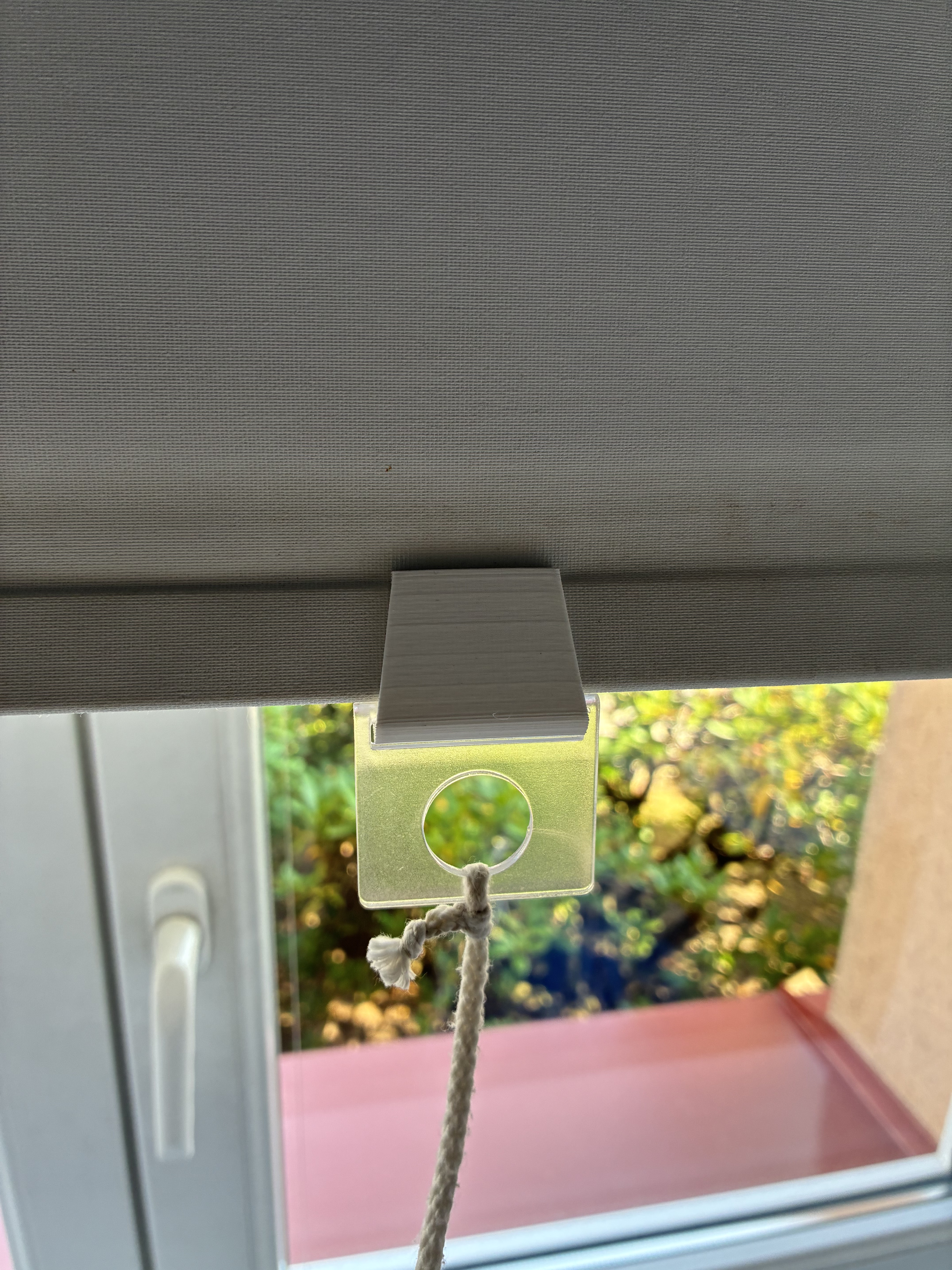 Roller shade cord holder