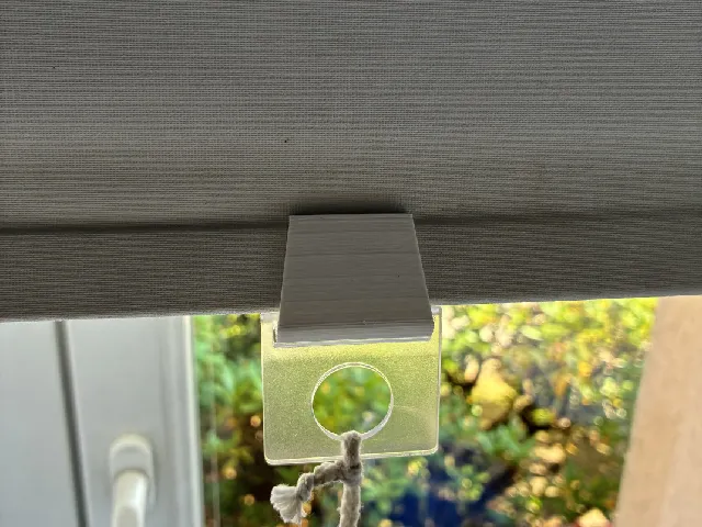 Roller shade cord holder