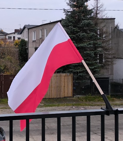 Flag holder for the balcony railing