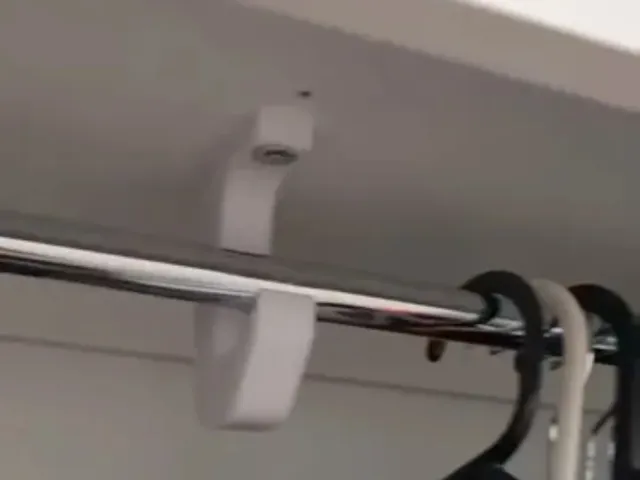 Coat hanger support arm