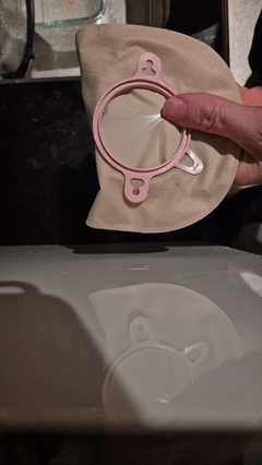 Aid to empty stoma/colonoscopy bag