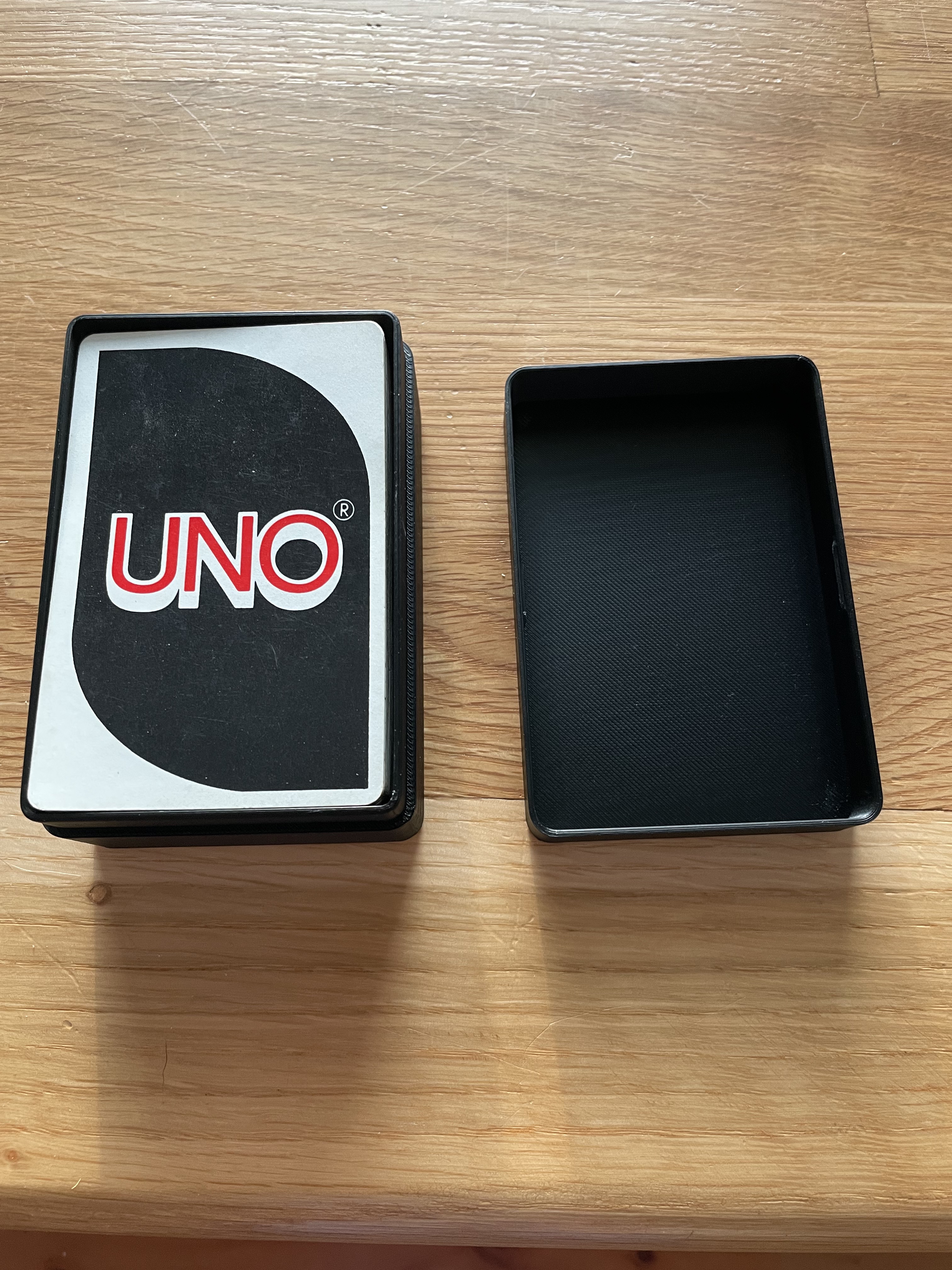 Uno card box with embossed snap lid.