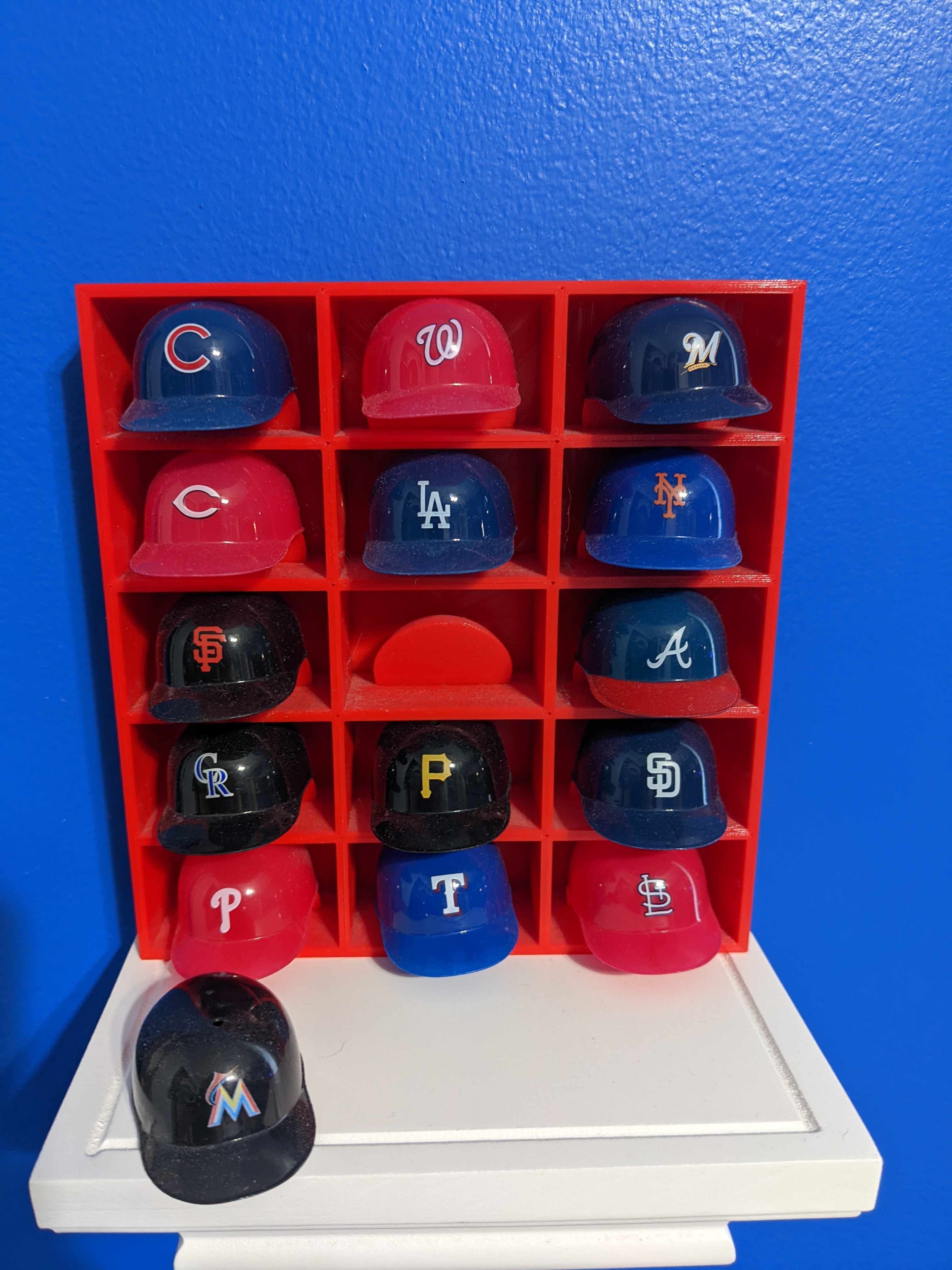 Shadowbox to display mini plastic baseball helmets by layer.works