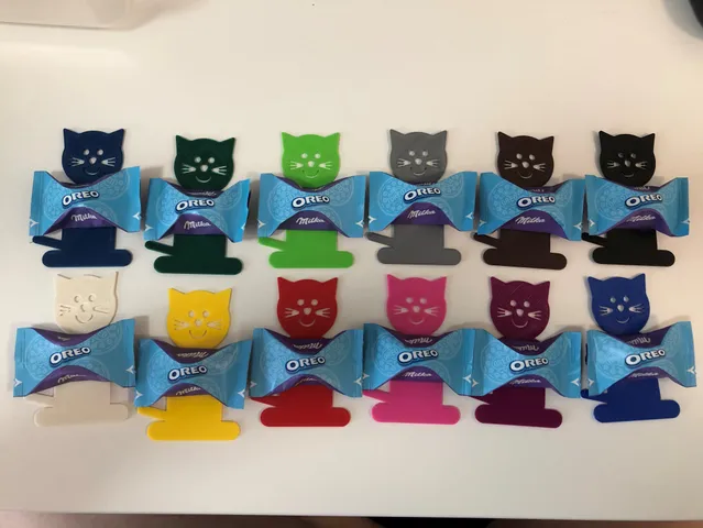 Cat holding bonbon