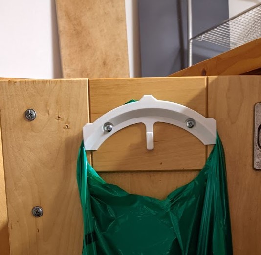 Holder/hock for easy access to plastic bag