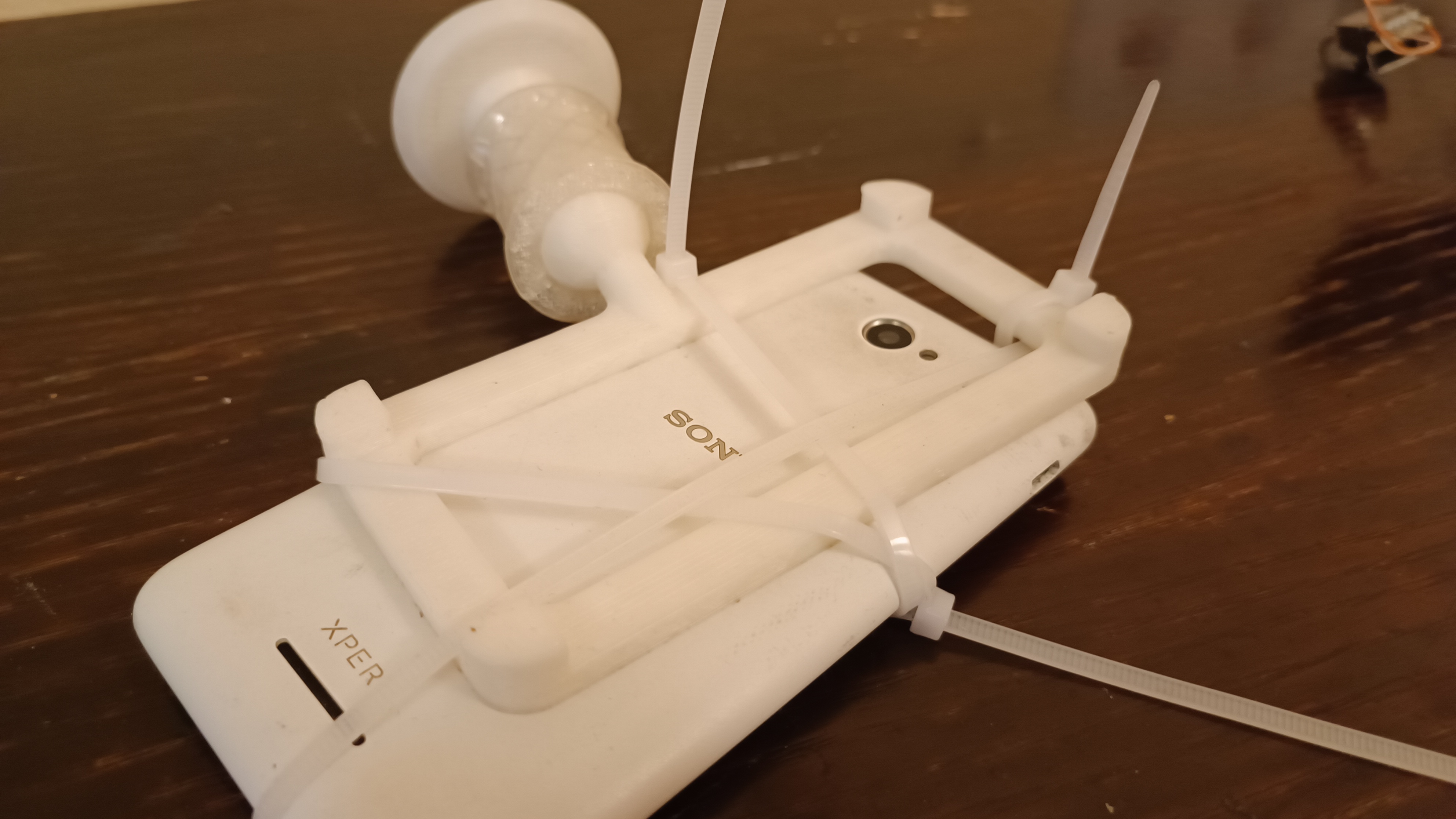 Phone mount - flexible, universal, permanent. Use zipties.