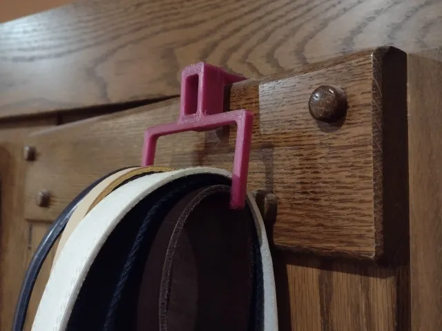 Kapstok voor aan de deur te hangen om broeksriemen en stropdassen op te hangen. Coat rack for hanging on the door to hang belts and ties.