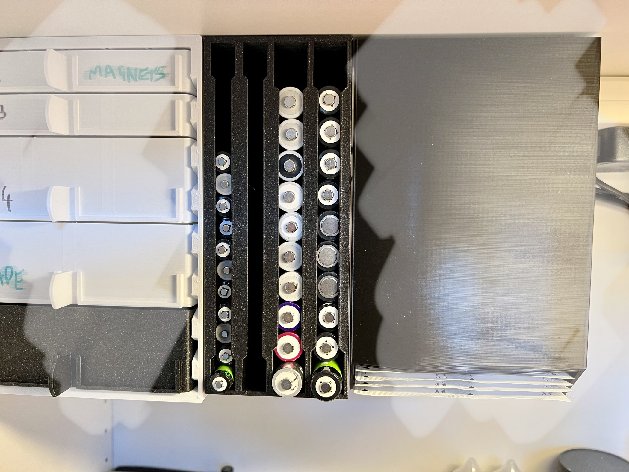 Top-mounted AA and AAA battery dispenser