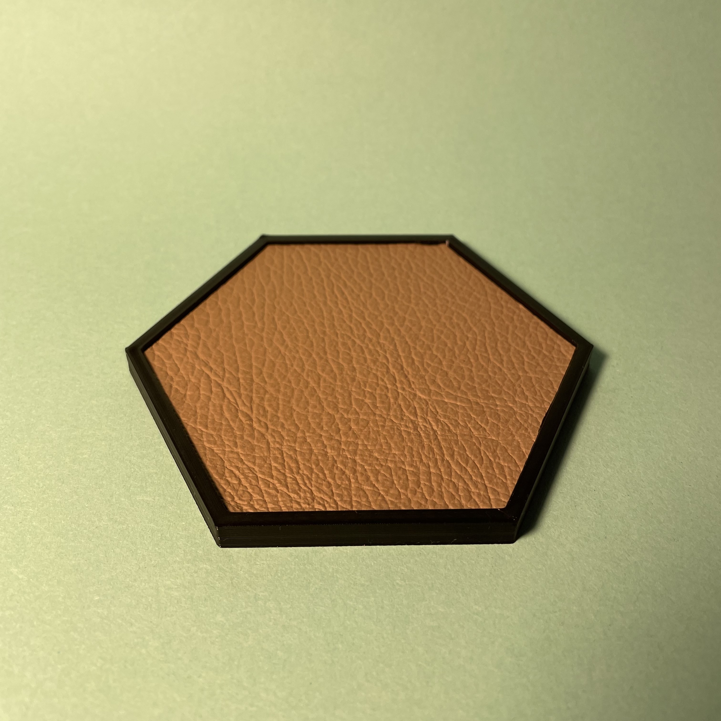Coaster with leather inlay