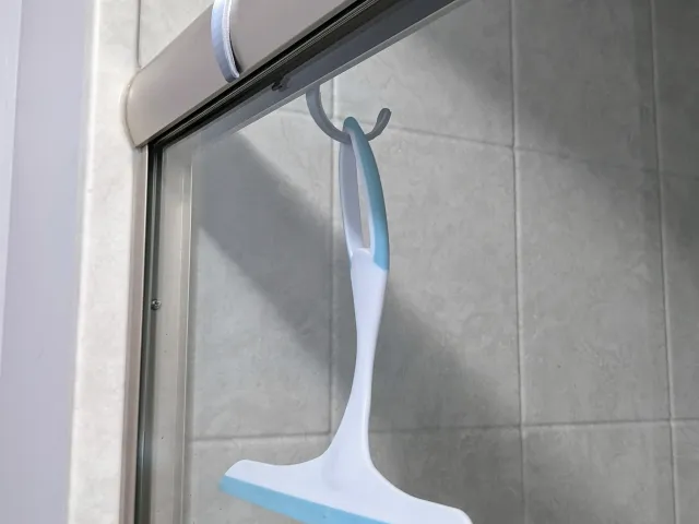 Shower squeegee / scraper hook