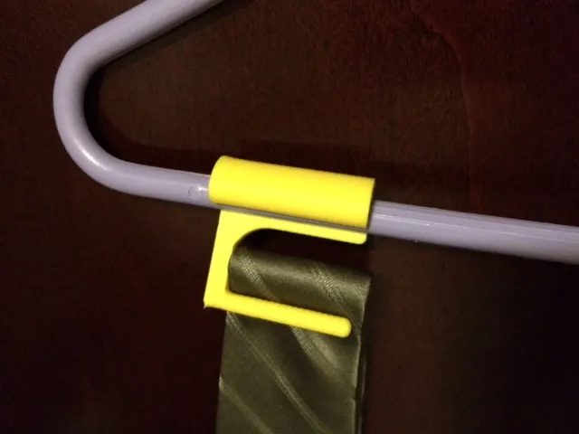 Clip-on neck tie holder for coat hanger