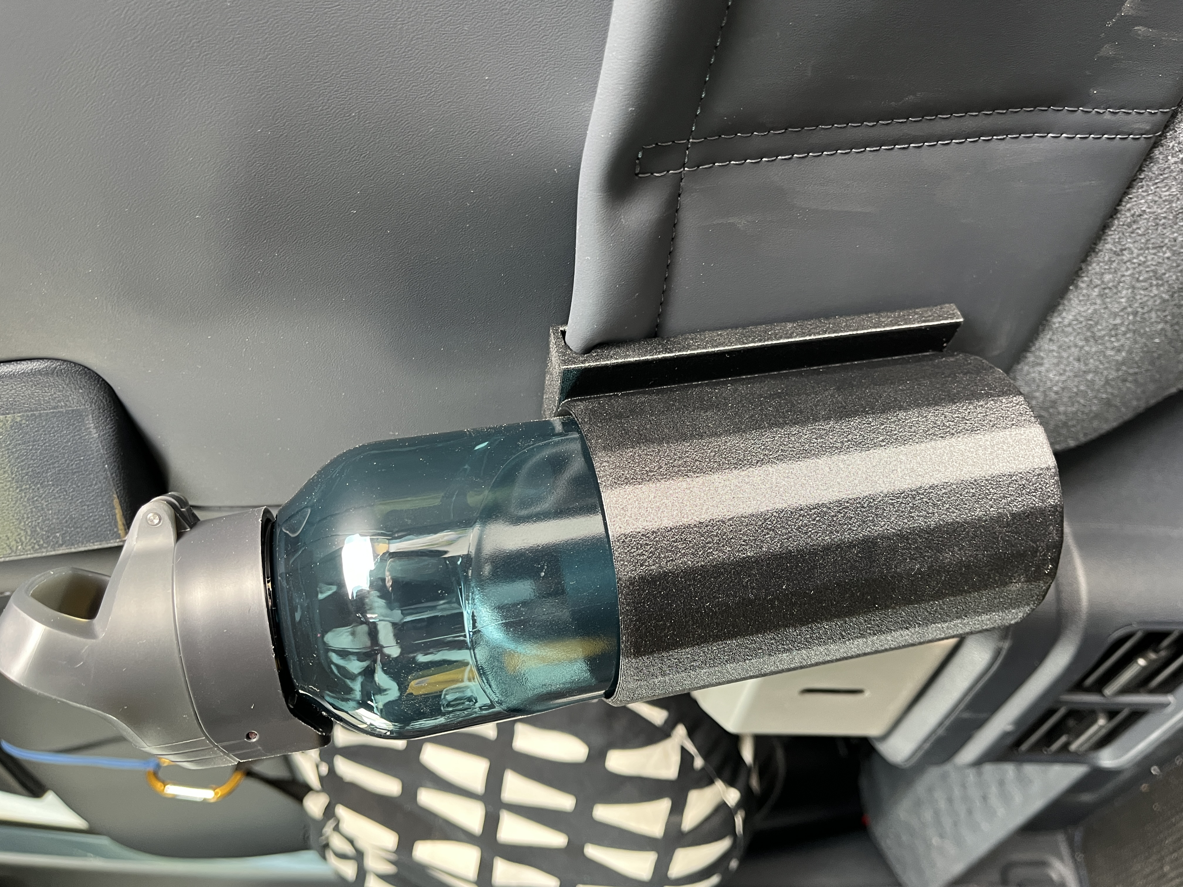 Simple bottle holder for the rear seat pockets in the Kia PV5
