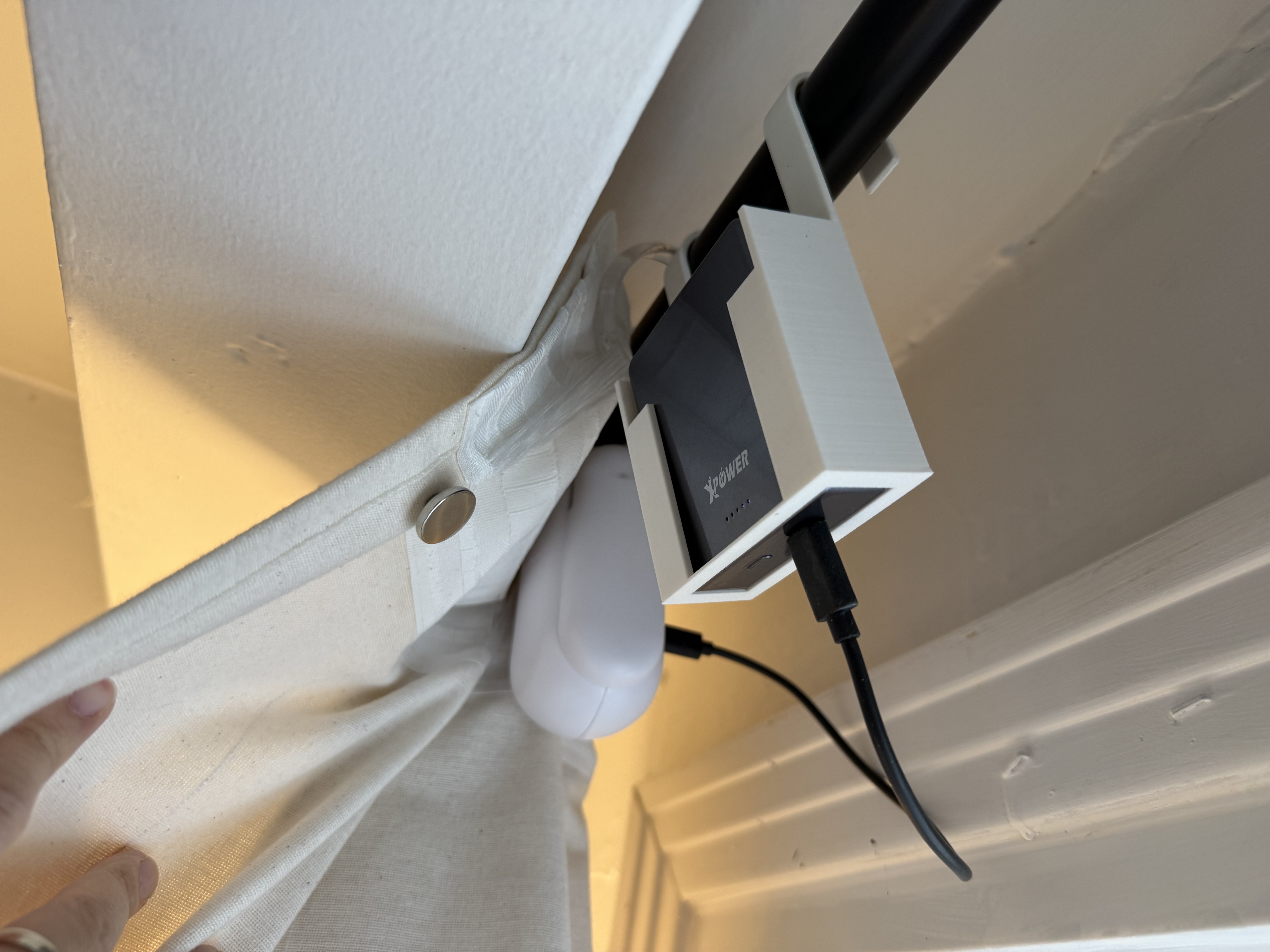 Powerbank holder for charging rod curtain robot