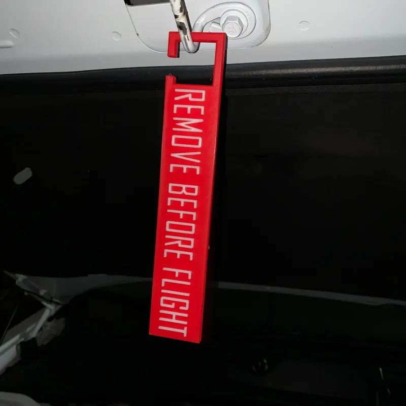 Remove Before Flight - Keychain by Iñigo Almazán Tife