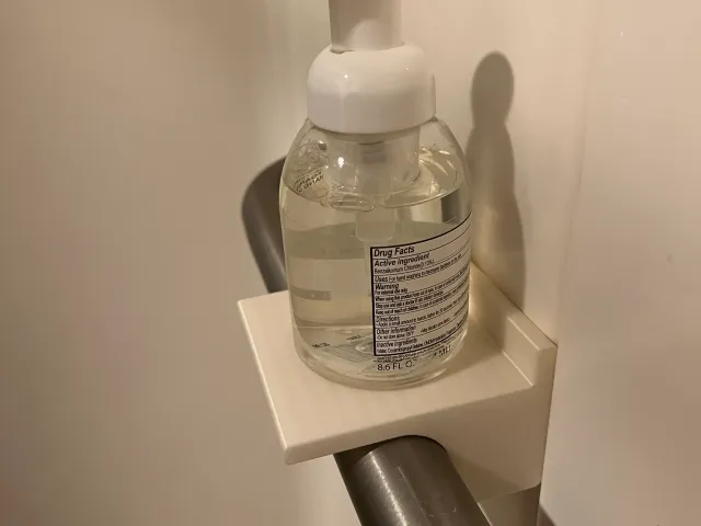 Shelf for shower grab bar