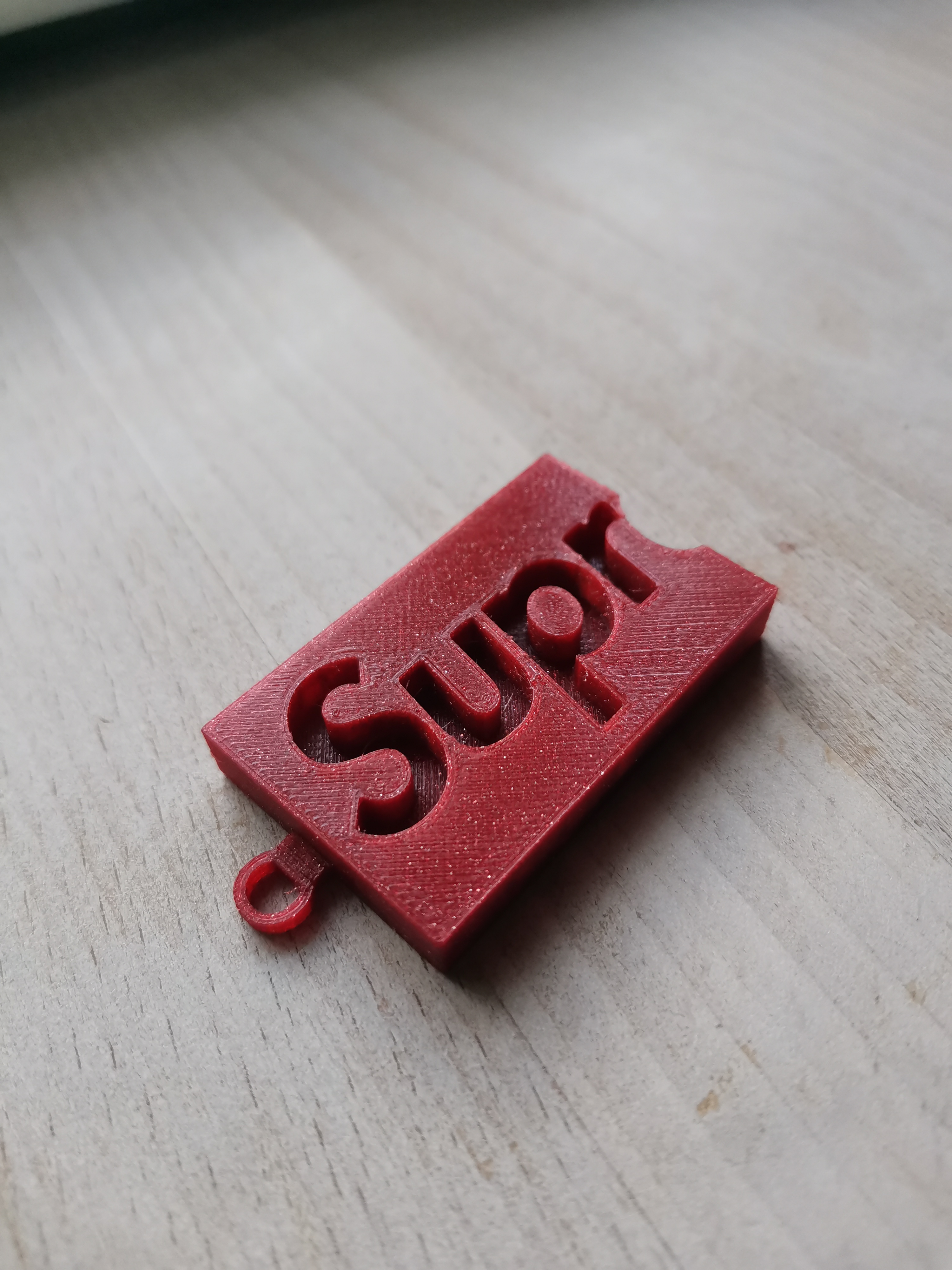 supreme logo keychain