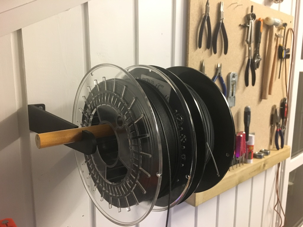 Wall mounted spool holder arm