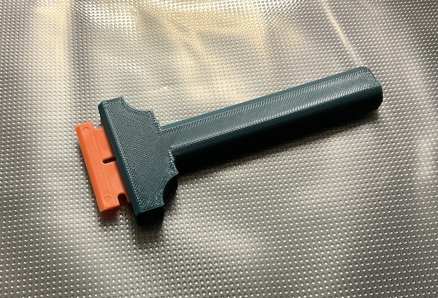 Scraper with replaceable plastic blades