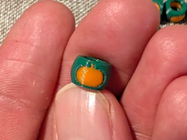 Pony bead with a pumpkin on it