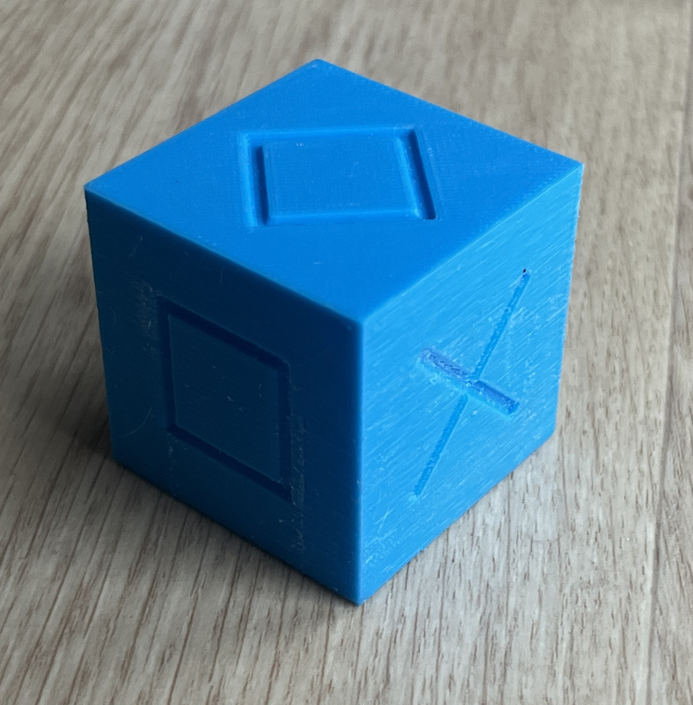 Model of a cube with different symbols on its faces