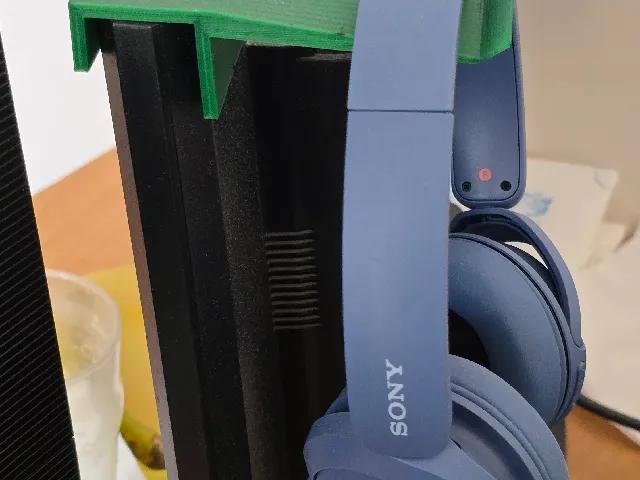Headphone stand on the back of a monitor