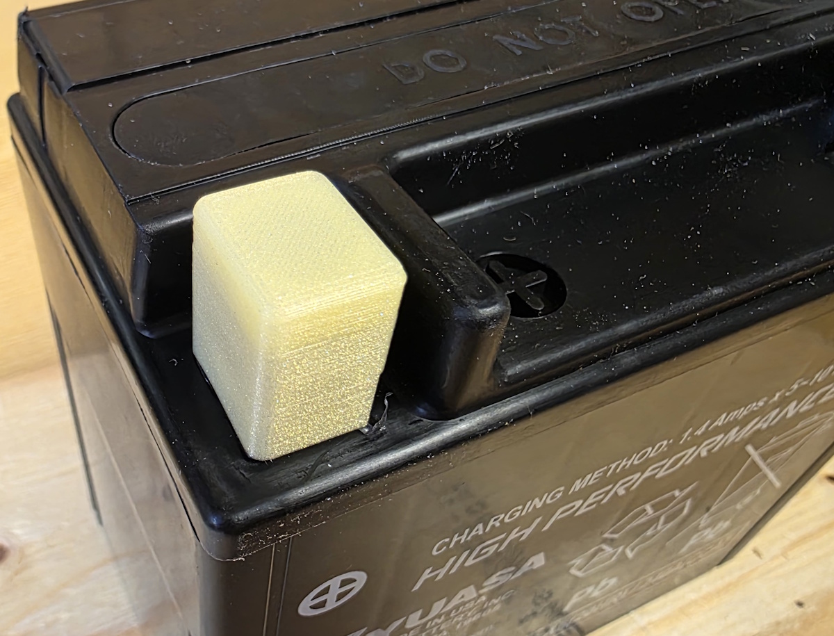 Motorcycle battery pole cover