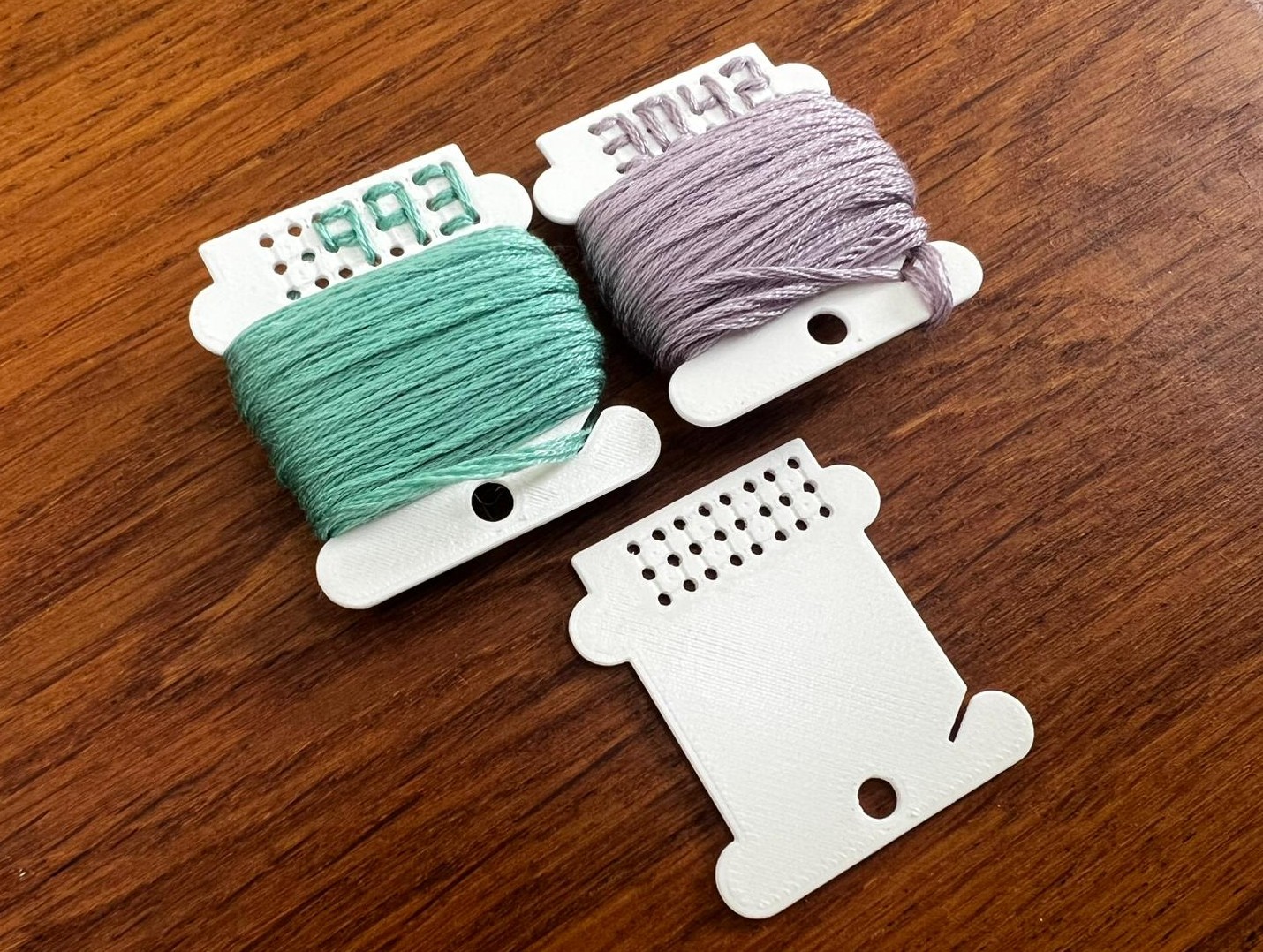 Embroidery bobbin with embroidered colour numbers