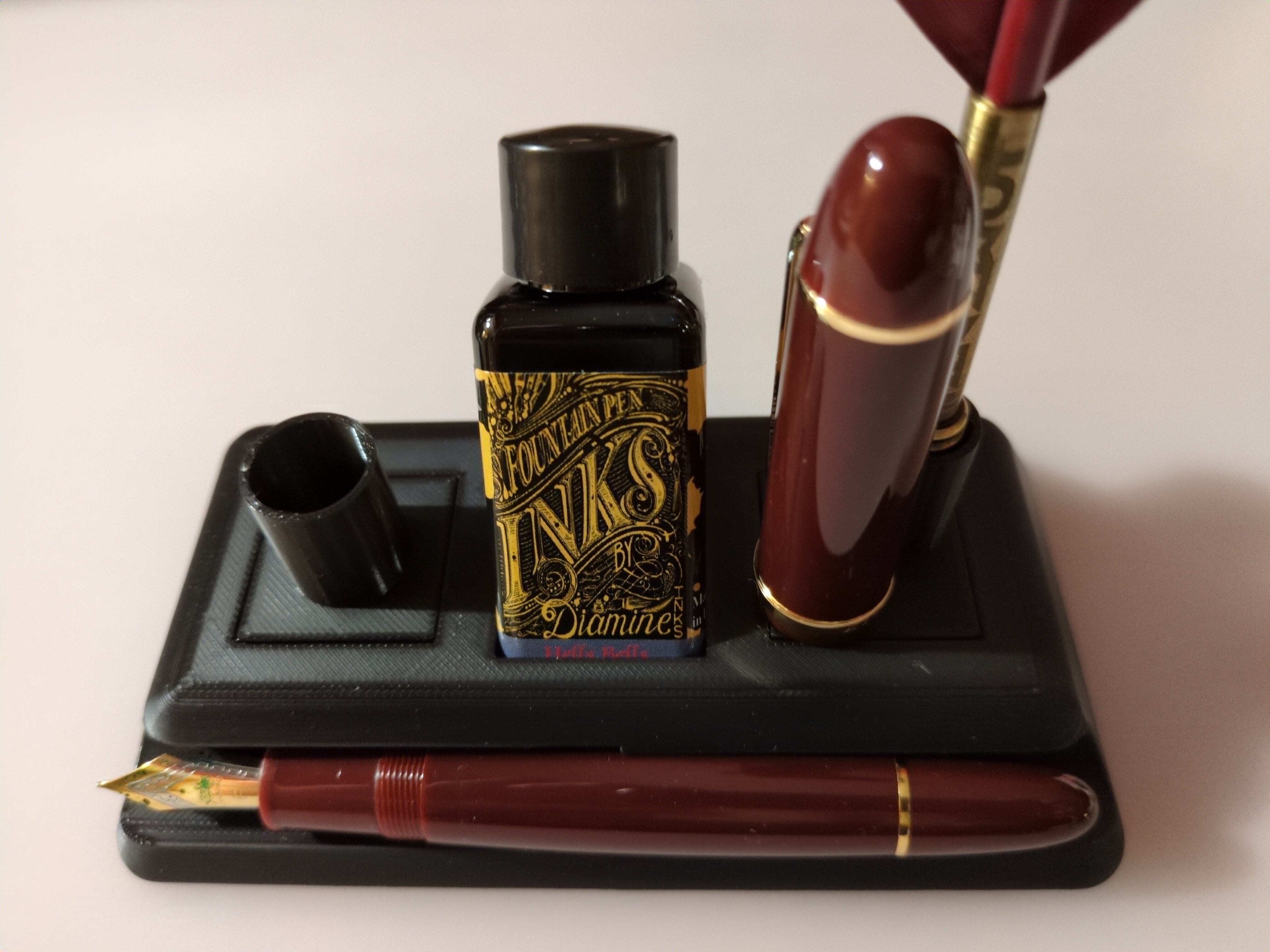 rest for big fountain pen, ink bottle and inkwell