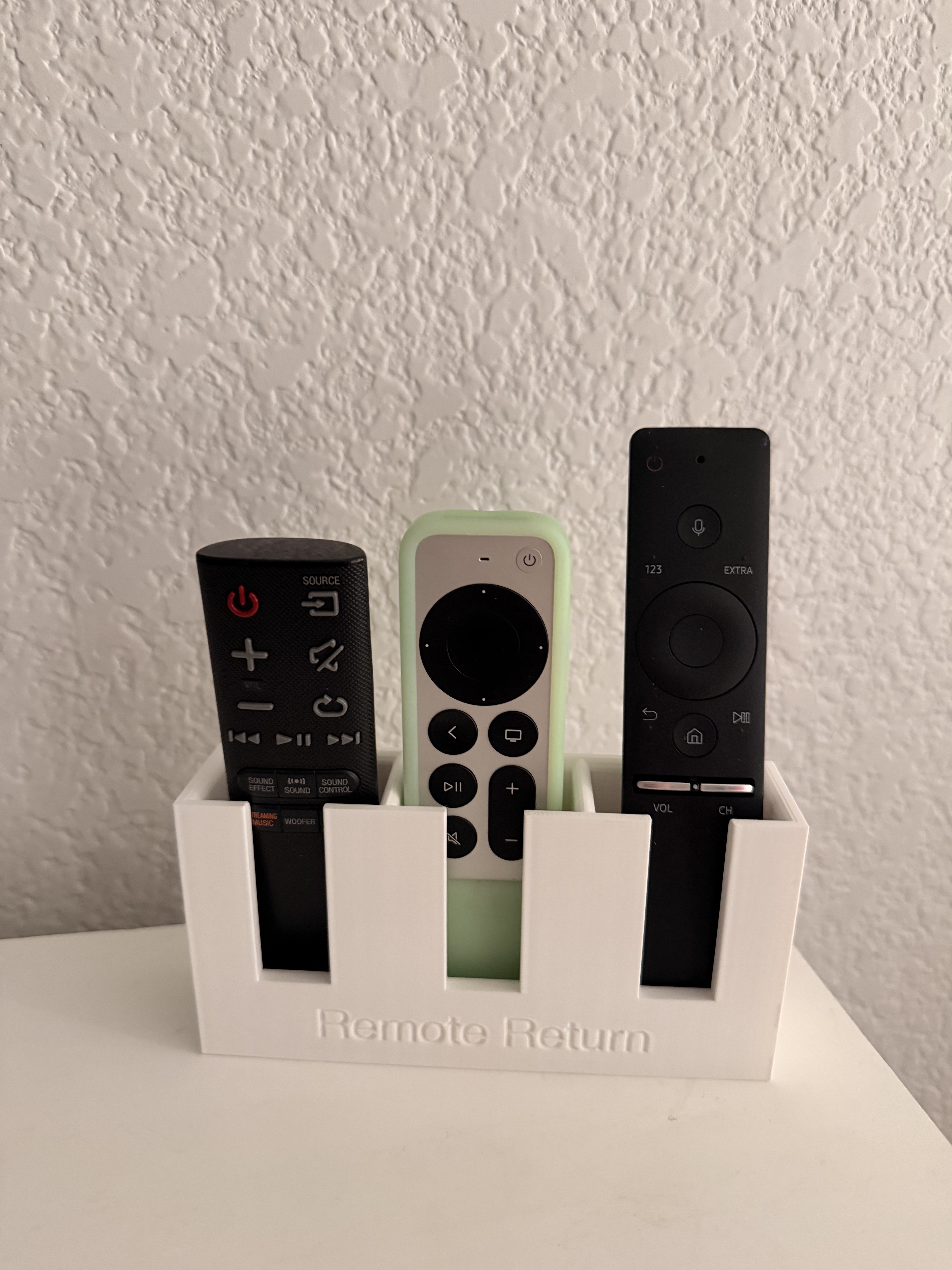 Apple TV and Samsung remote holder.