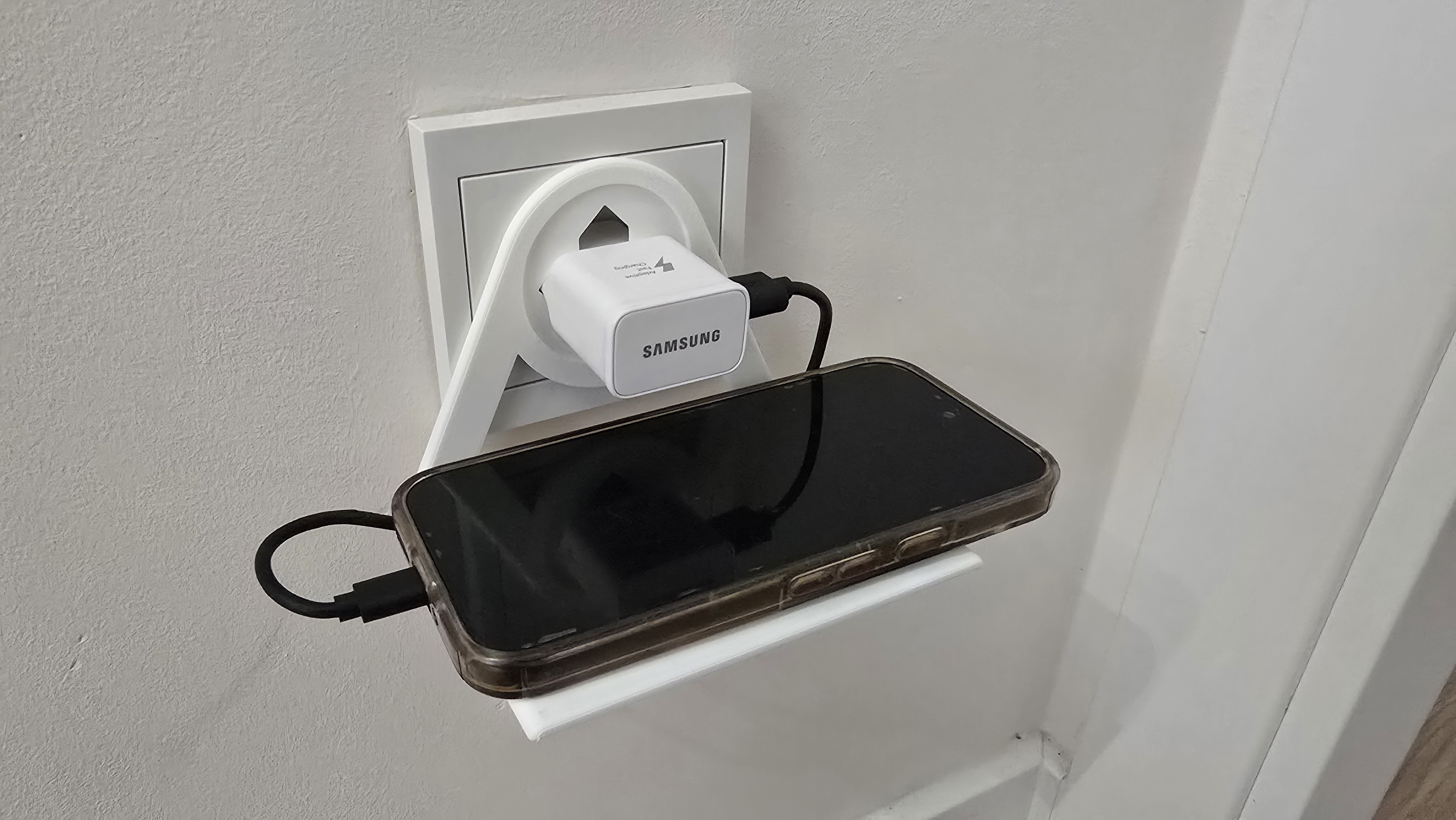 Mobile phone holder plugged into a European socket