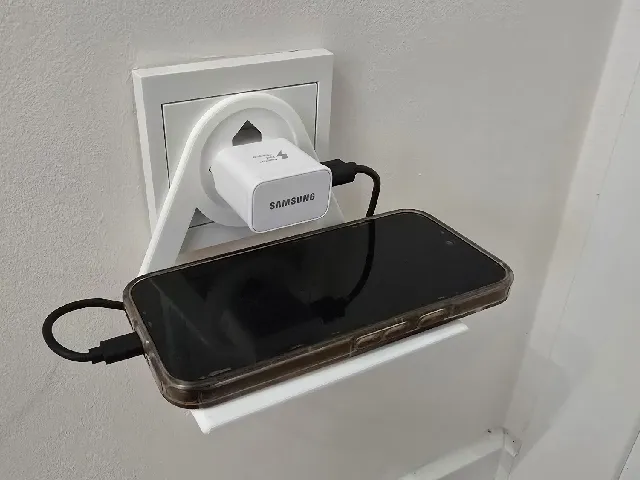 Mobile phone holder plugged into a European socket