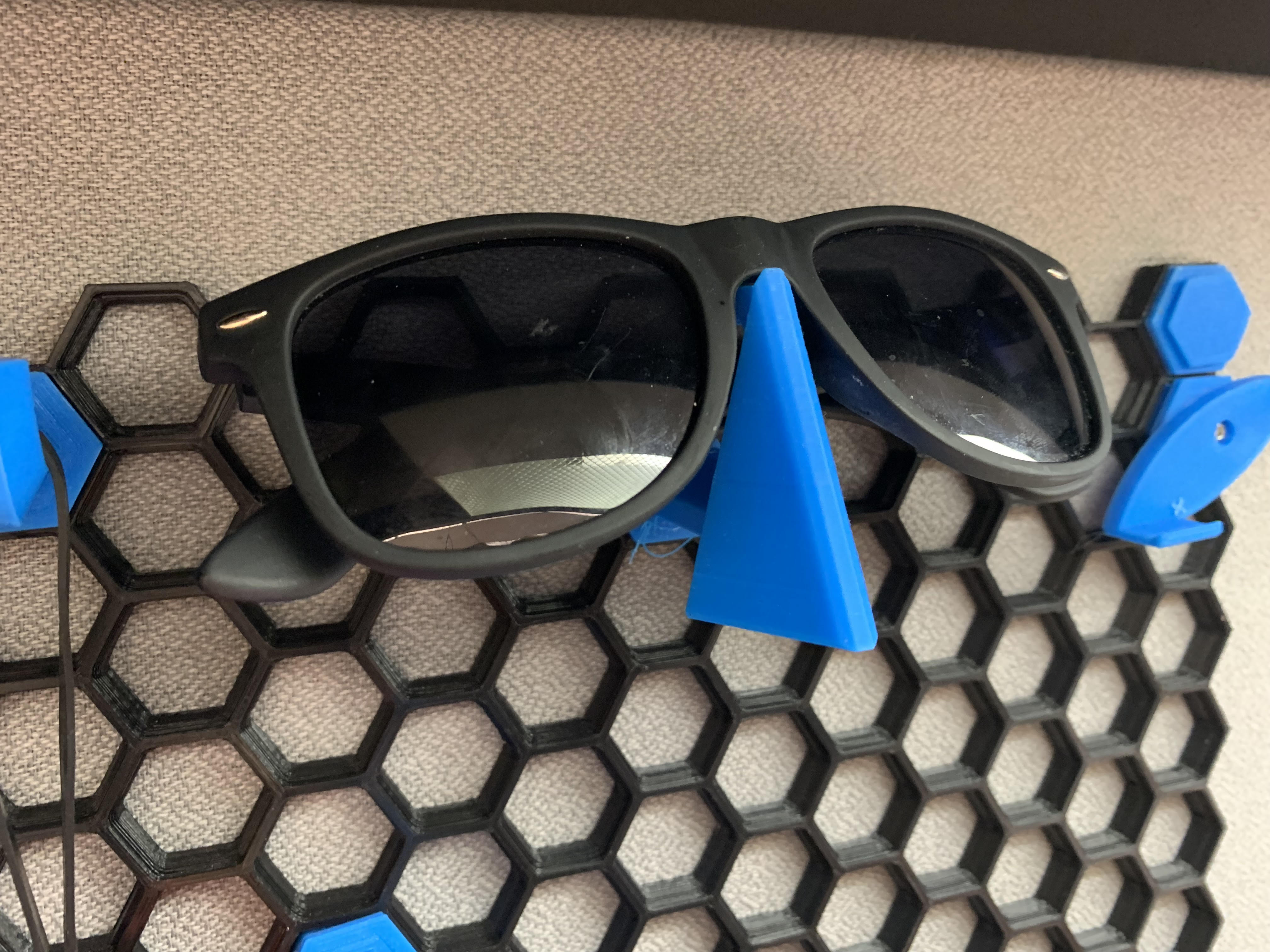 Sunglasses, glasses, and goggle holder for honeycomb storage wall