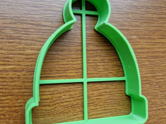 Cookie cutter in the shape of a hat with pompom
