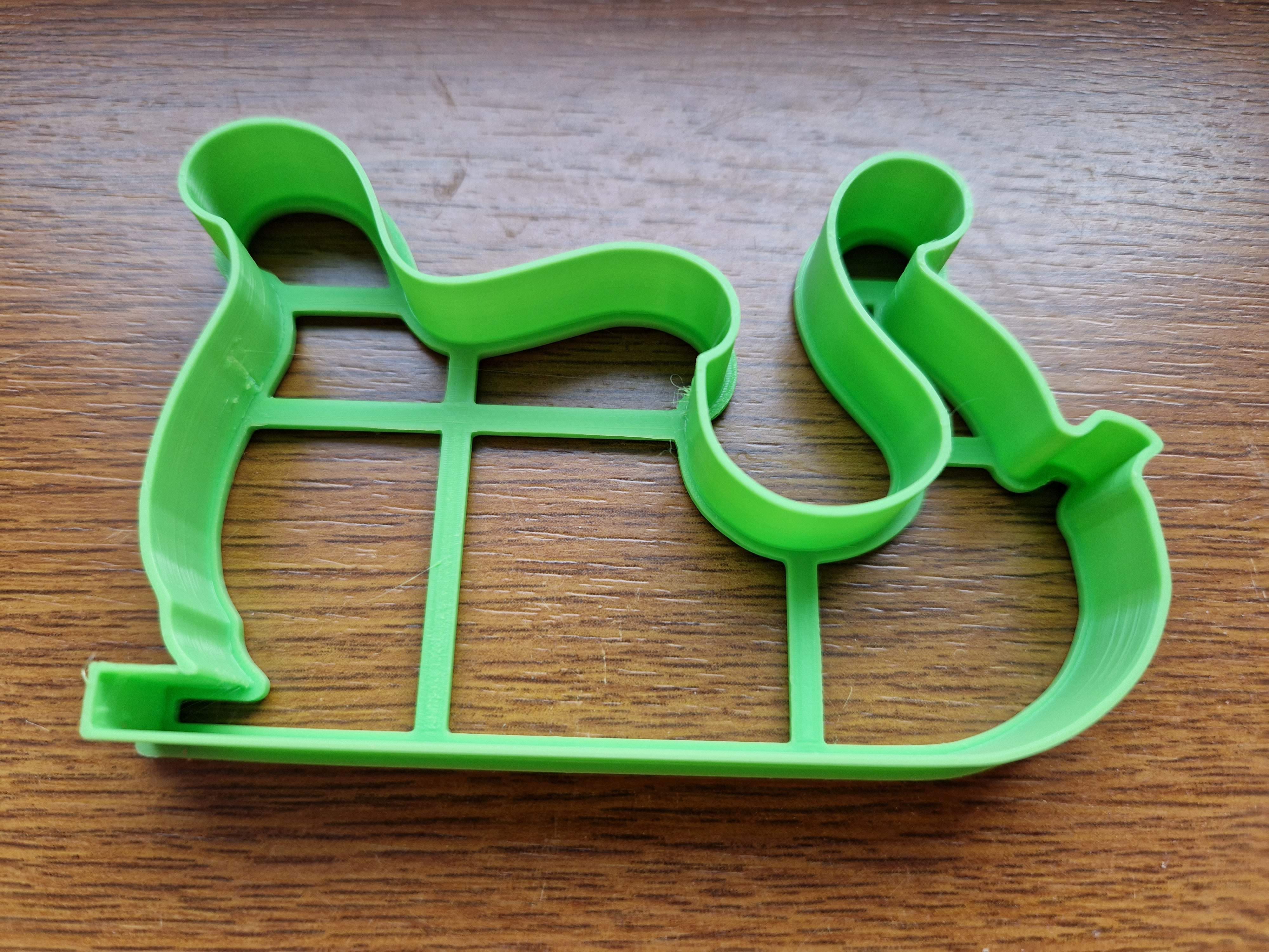 Cookie cutter in the shape of a Santa Claus sled