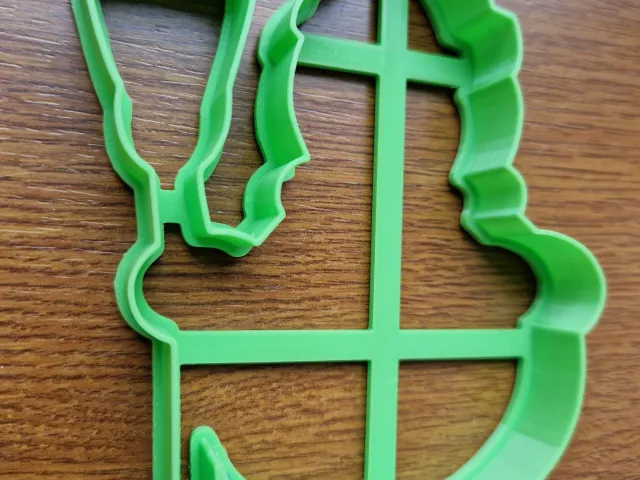 Cookie cutter in the shape of a snowman with a broom