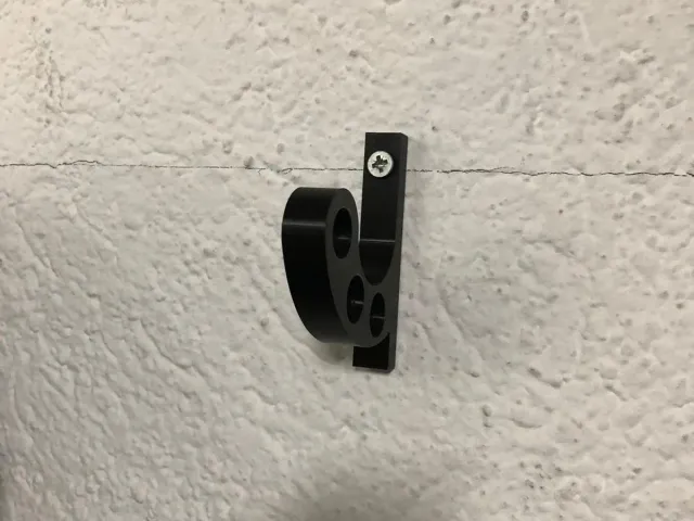 Wall mounted motorcycle helmet holder