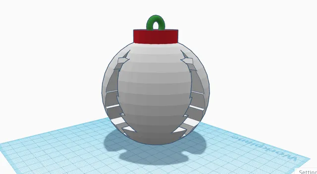 A Christmas tree ornament with tree holes in each side