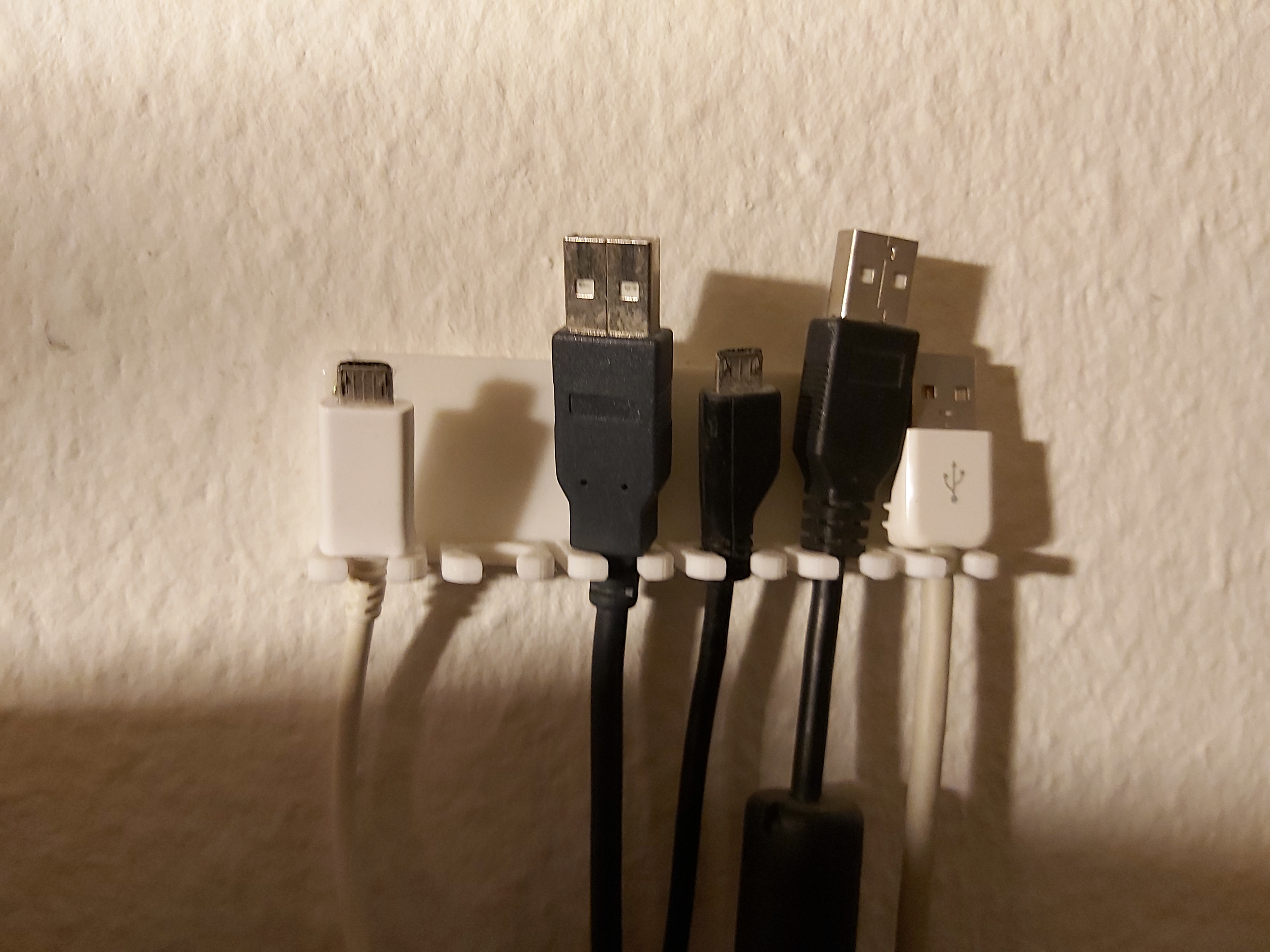 Wallmounted USB-cable holder