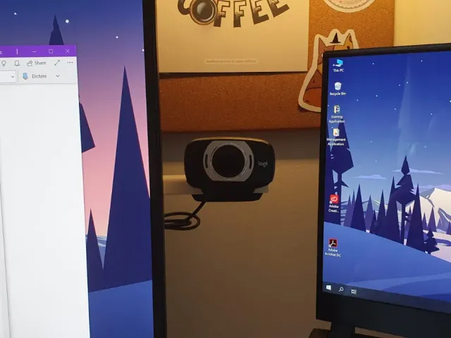 Hideable webcam mount behind monitor