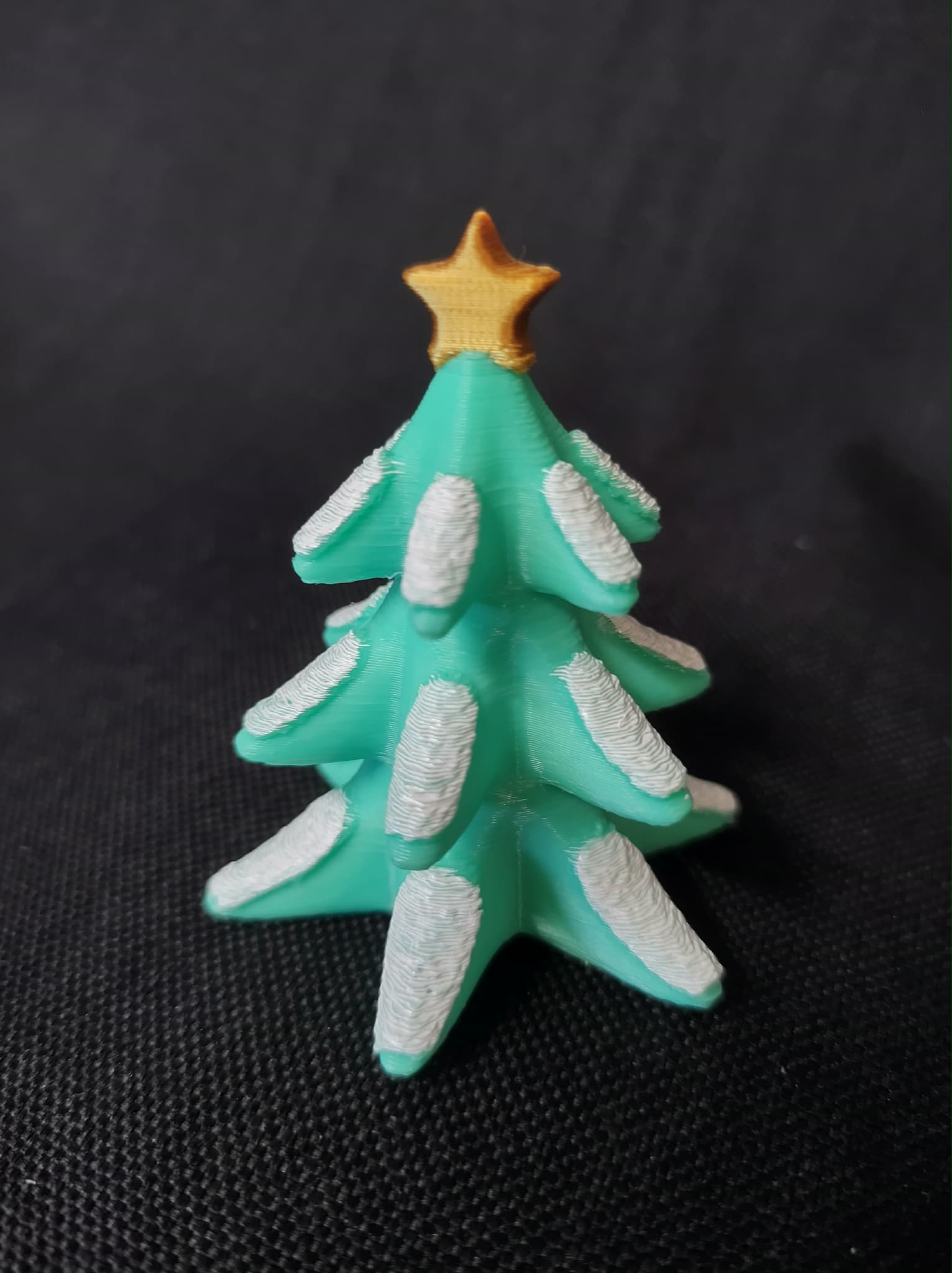 Snowy Christmas Tree topped with a Star Figurine
