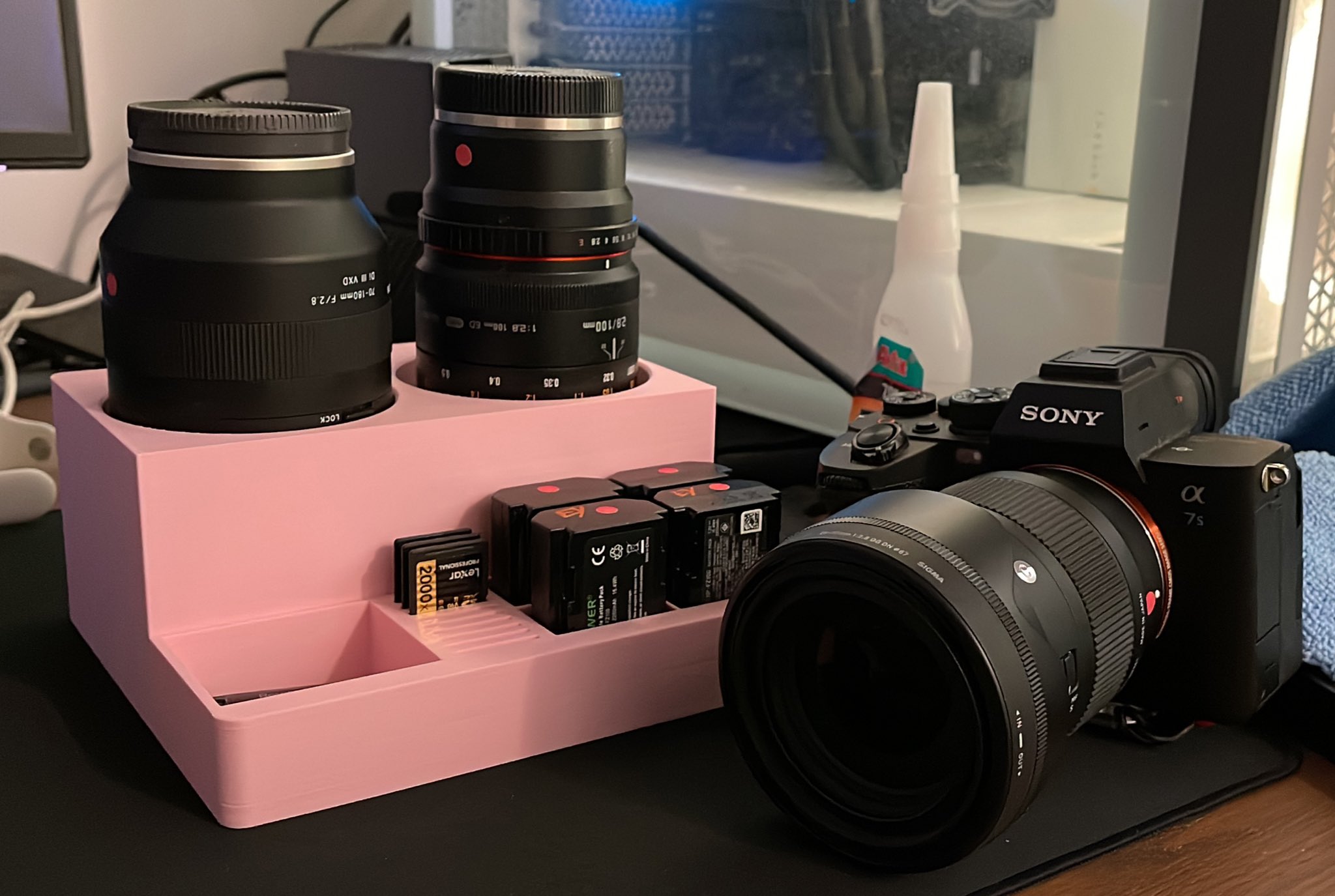 Camera lens, battery, and SD card station